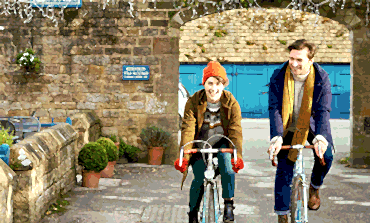 Young-man-and-woman-with-bicycles-in-the-Peak-District-area-of-Derbyshire-370x223